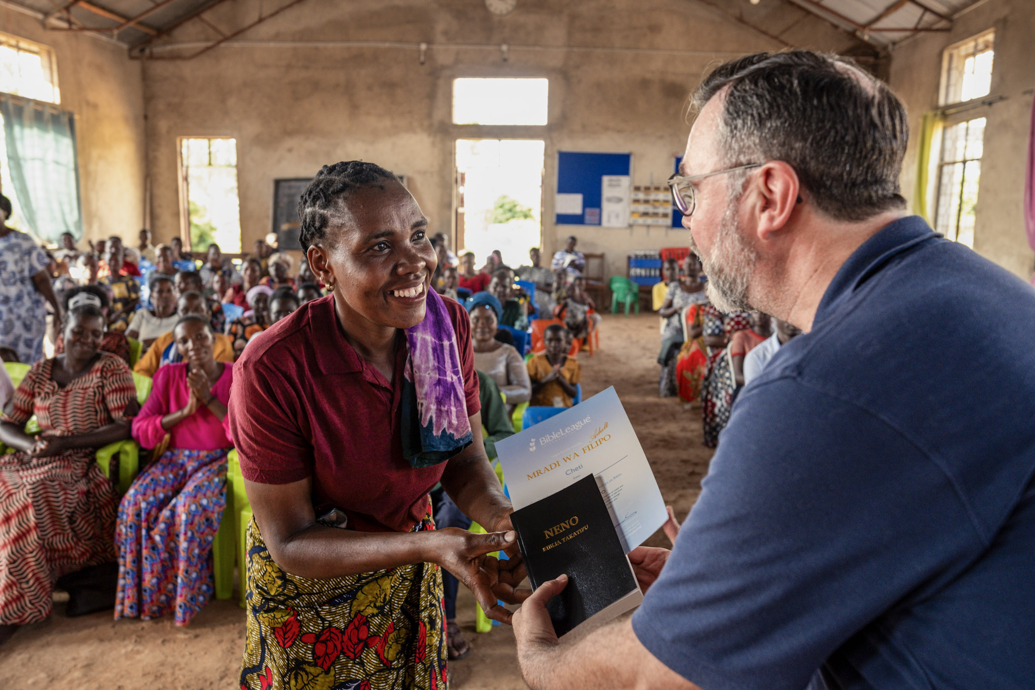 Tanzania Certificates And Bibles With Anton helping out to give bibles and certificate.